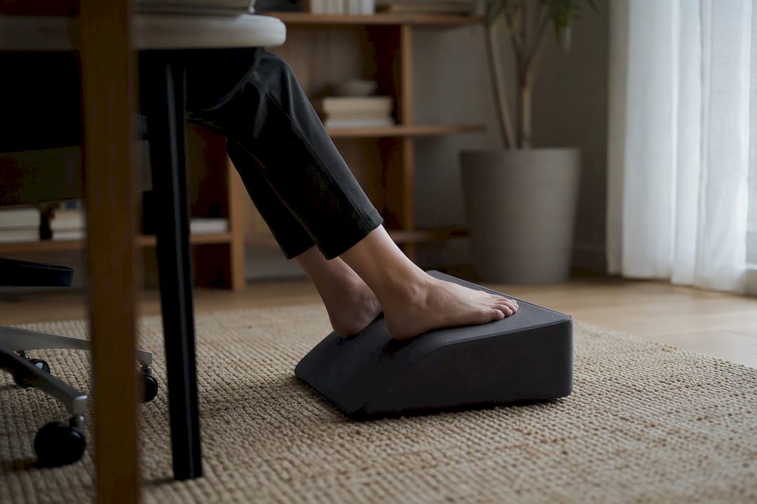 Person adjusting foot on angled footrest
