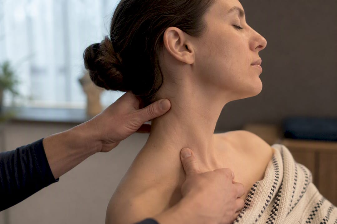 Hands gently massaging SCM muscle on neck