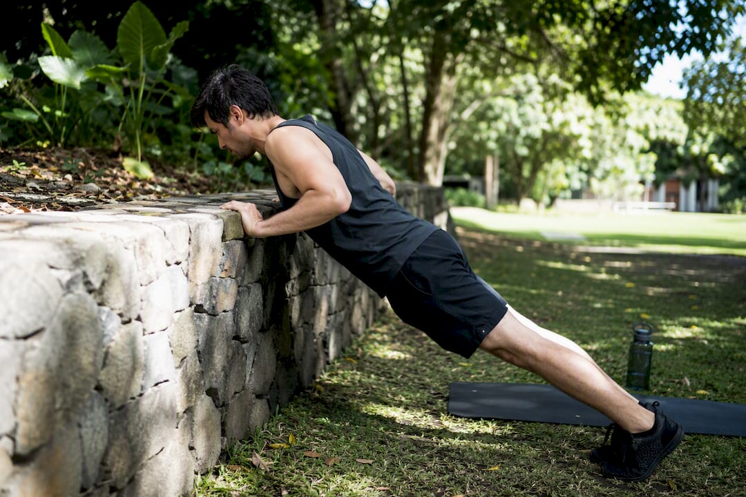 Person performing incline push-up plus exercise