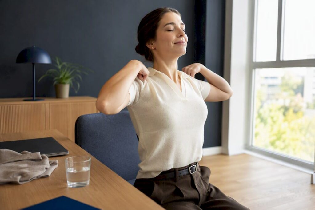Office worker performing shoulder rolls